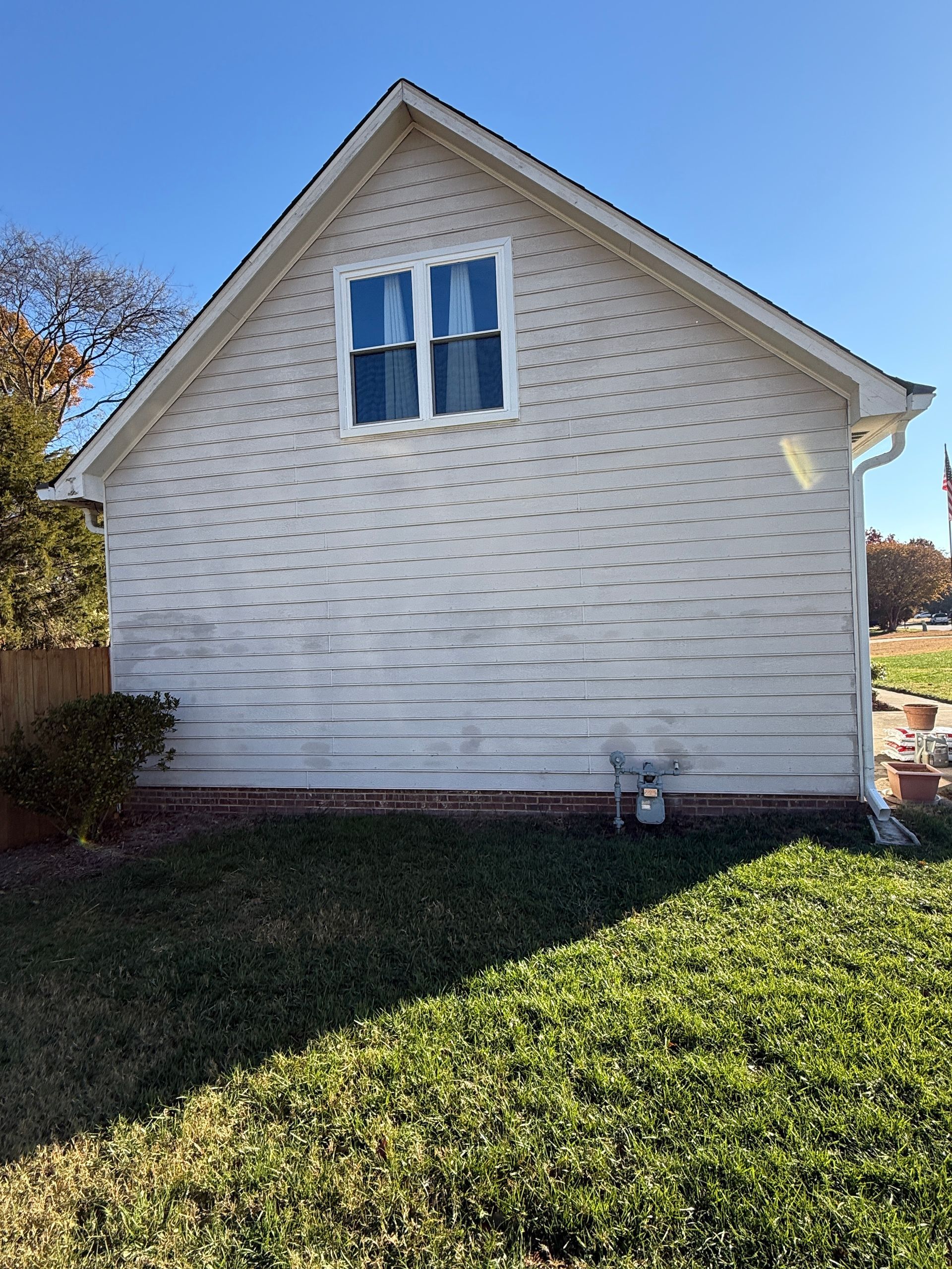 Bathroom with sink, mirror, and light fixture. Cream-colored walls, white vanity, and silver fixtures.