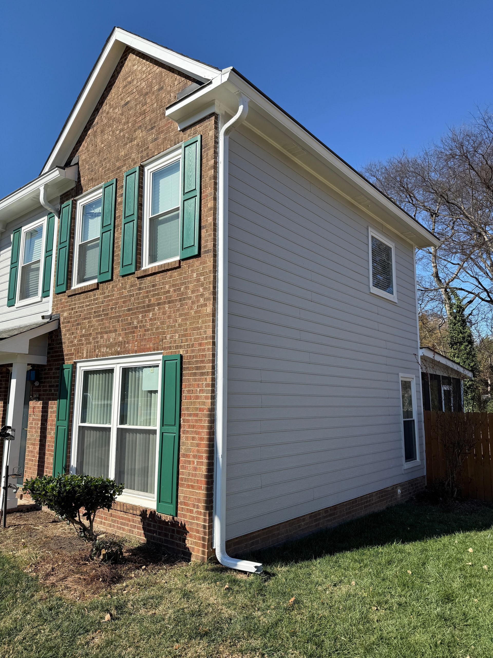 Bathroom with a vanity, mirror, and light fixture; light blue walls.