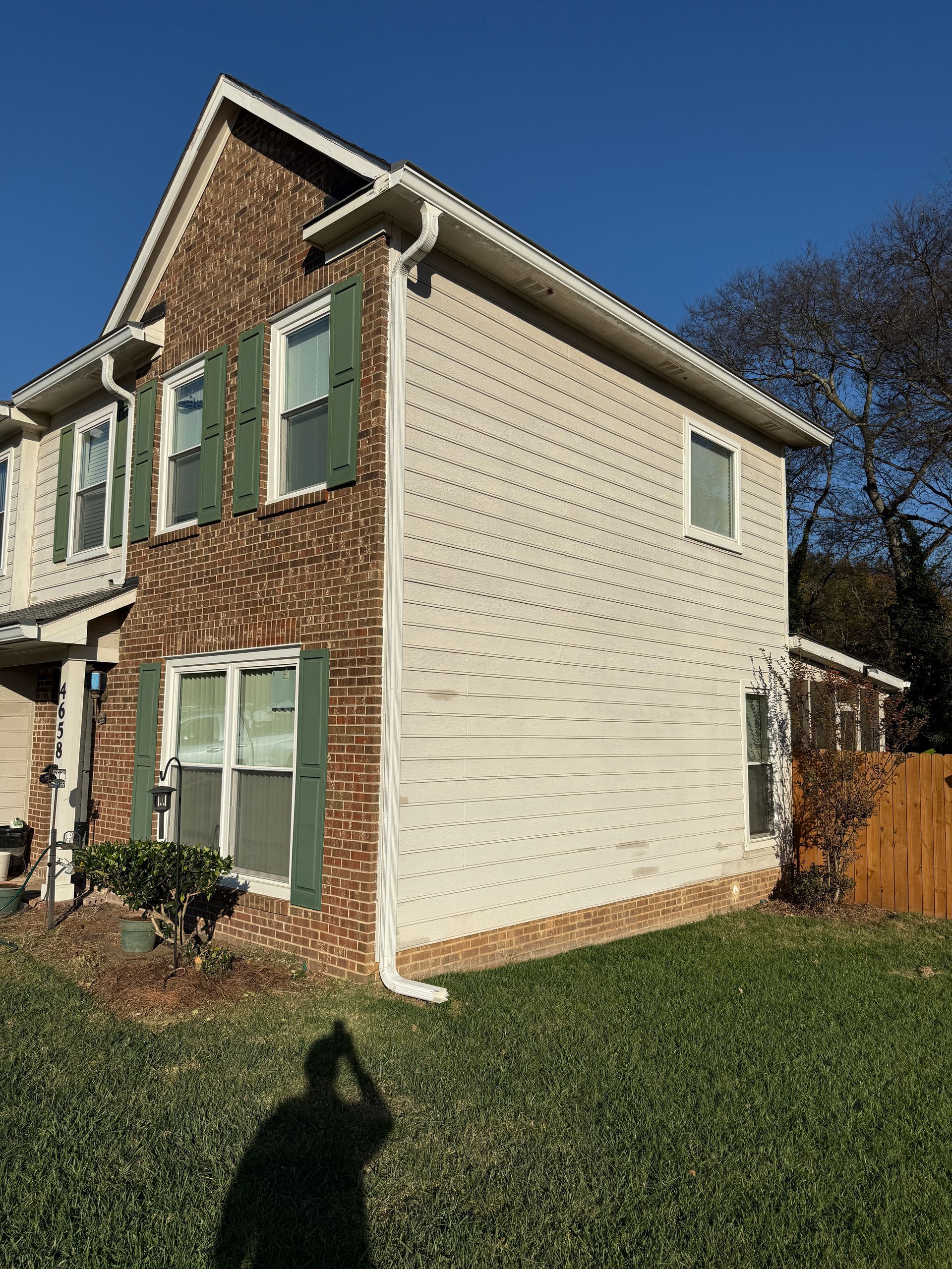 Bathroom with sink, mirror, and light fixture. Cream-colored walls, white vanity, and silver fixtures.