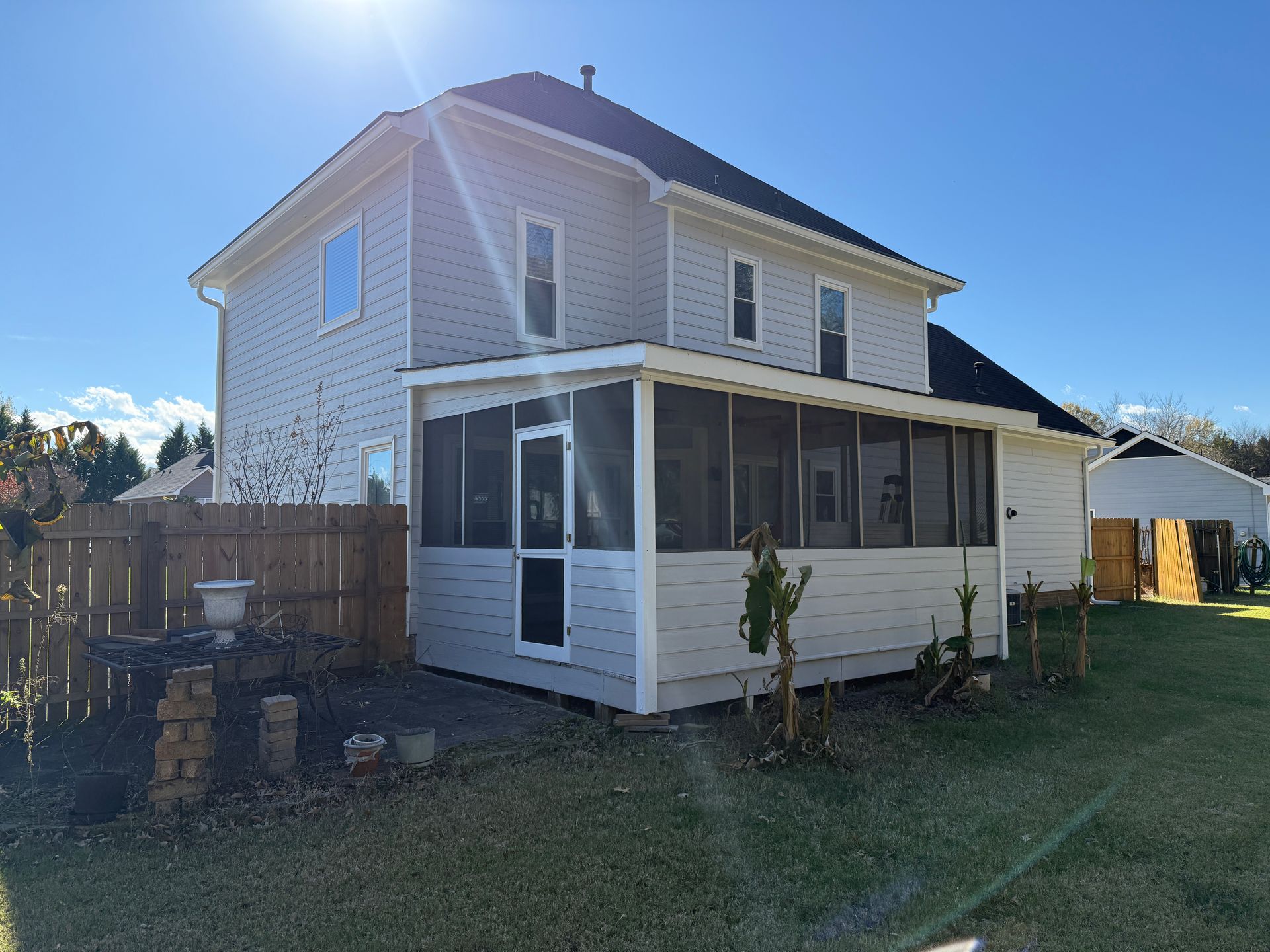 Wooden staircase with white risers and brown treads, wooden handrail, leading upward.