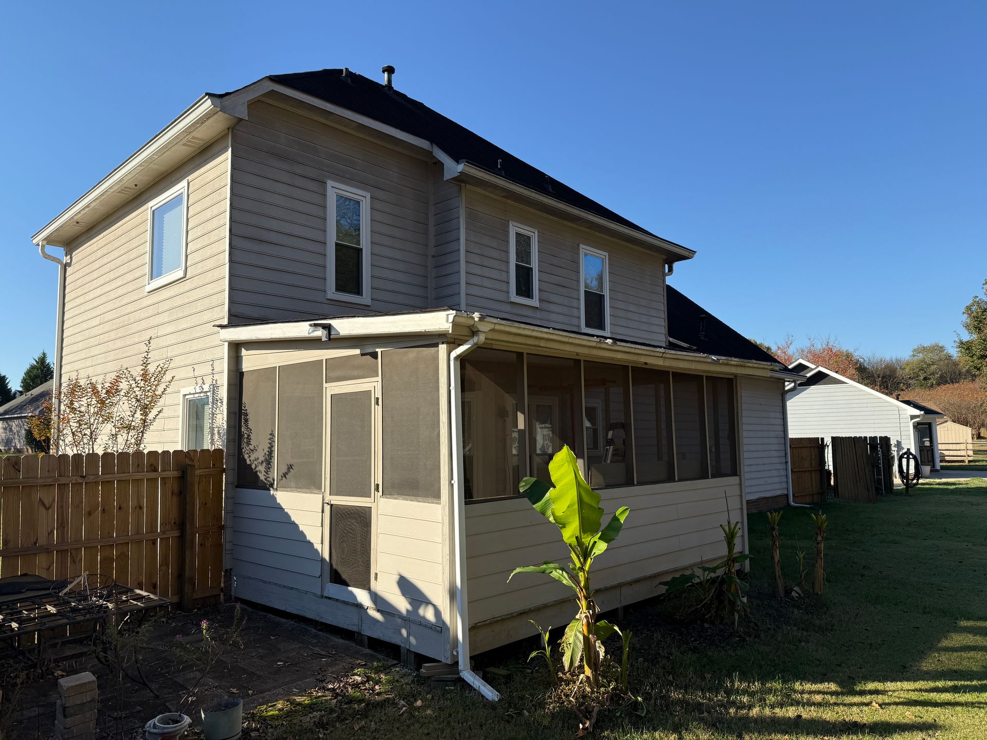 Wooden staircase with white banisters and a baby gate.