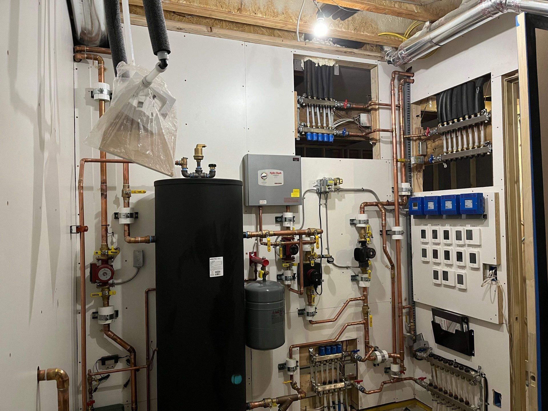 High-efficiency boiler installation in the basement with radiant floors and an indirect water heater.