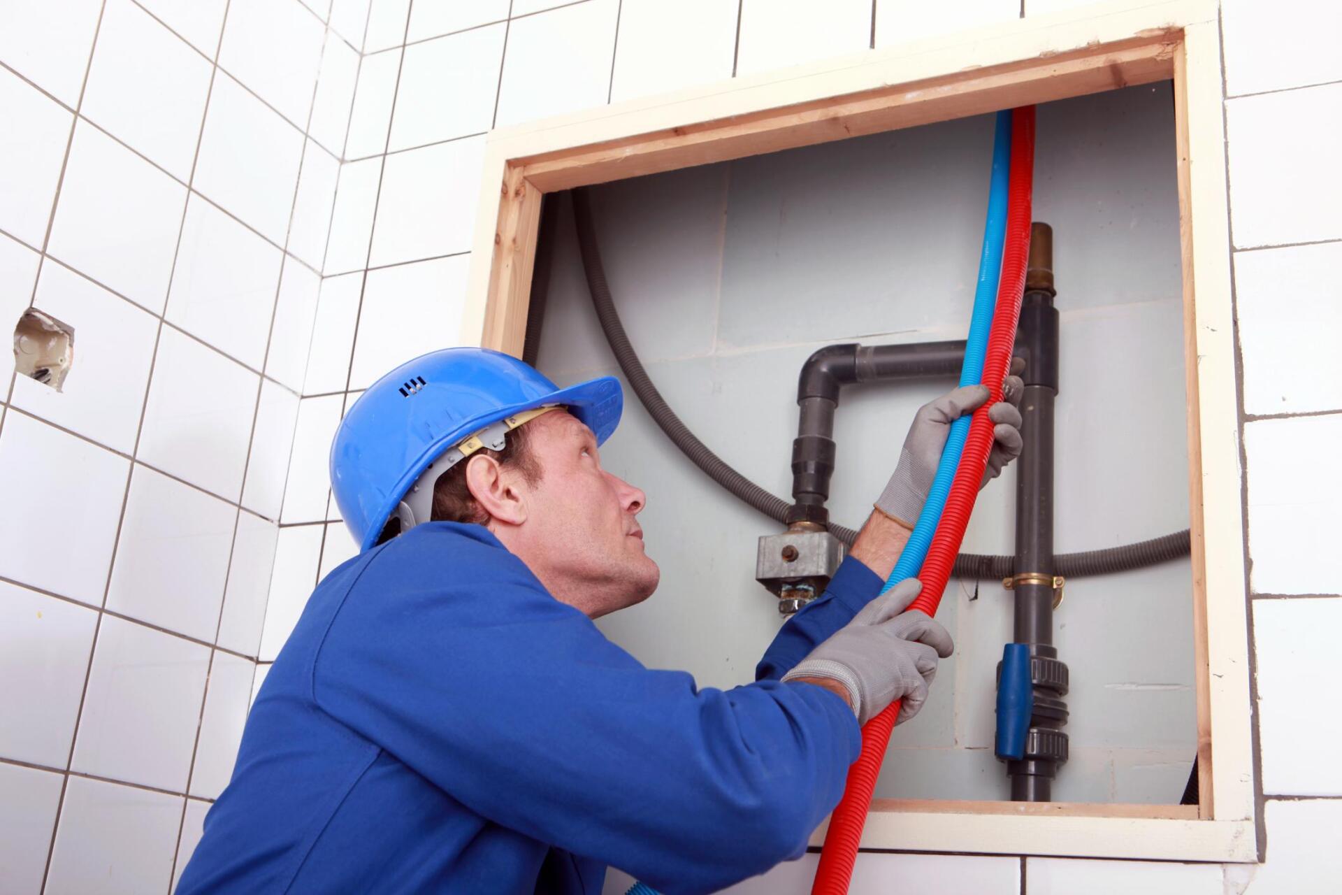 a plumber man installing another pipe