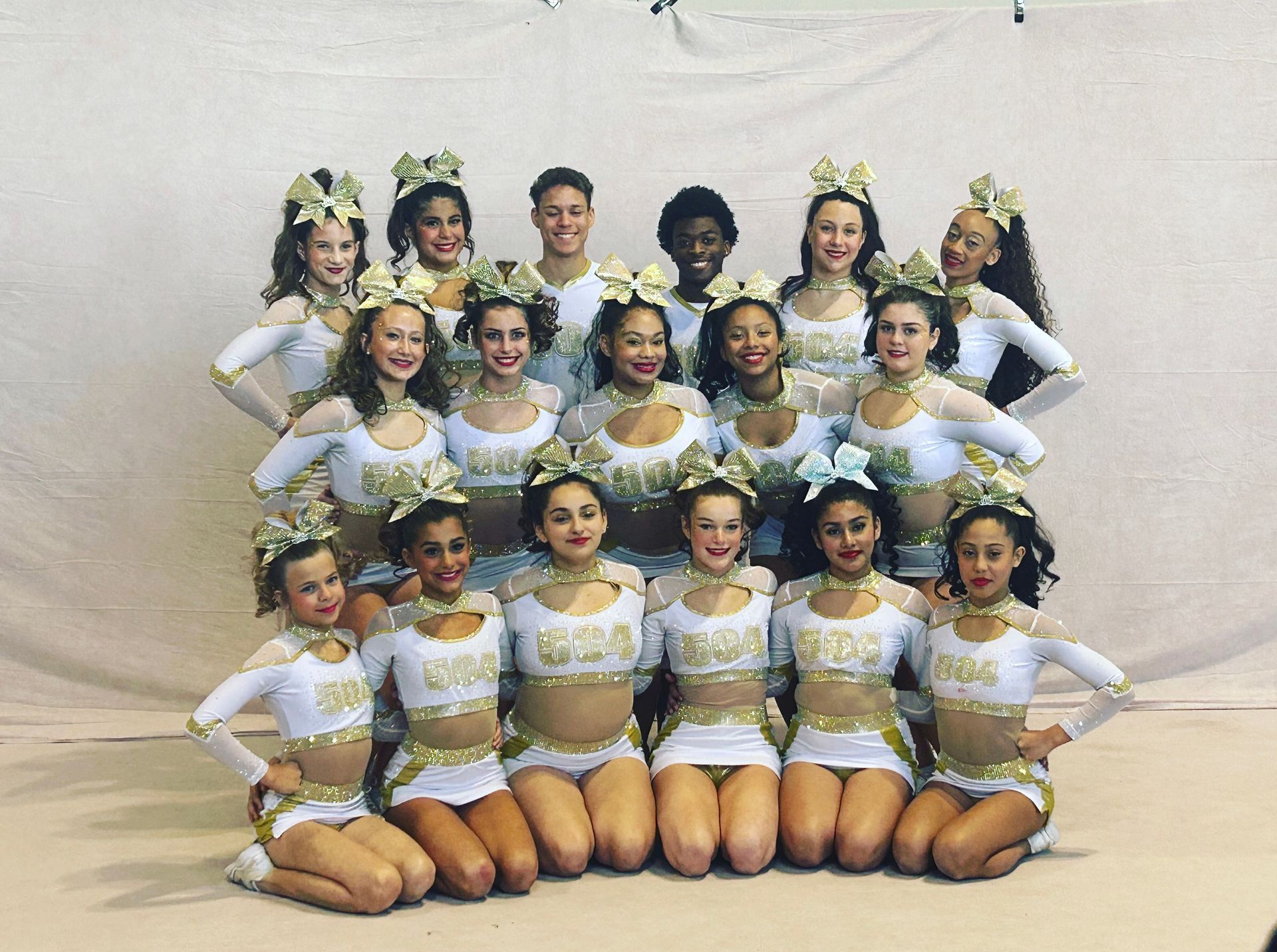 A group of cheerleaders are posing for a picture