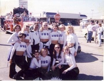 A group of women wearing uno shirts pose for a photo