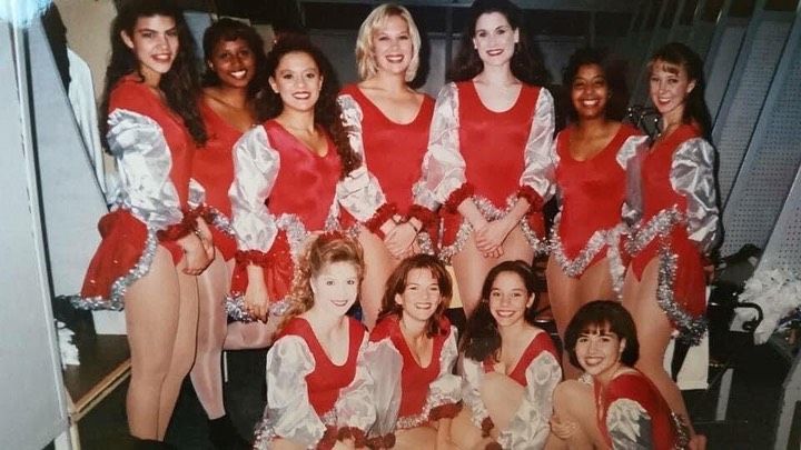 A group of cheerleaders are posing for a picture together