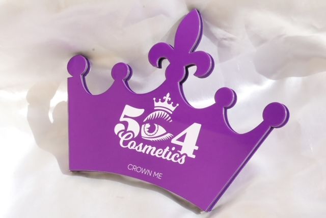 A purple crown that says 504 cosmetics on it