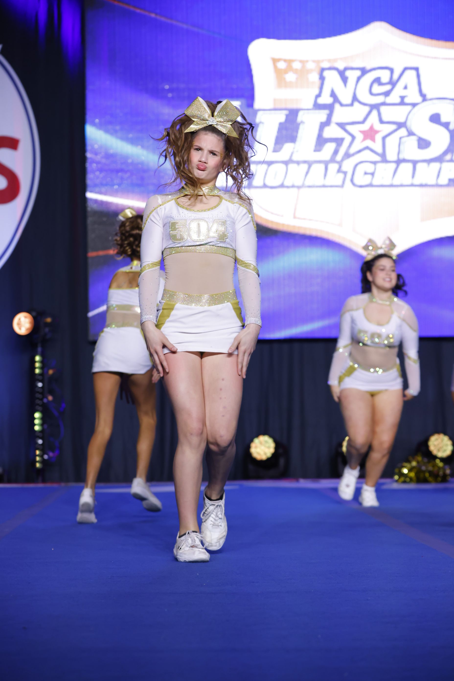 A group of cheerleaders are performing on a stage at the ncaa national championships