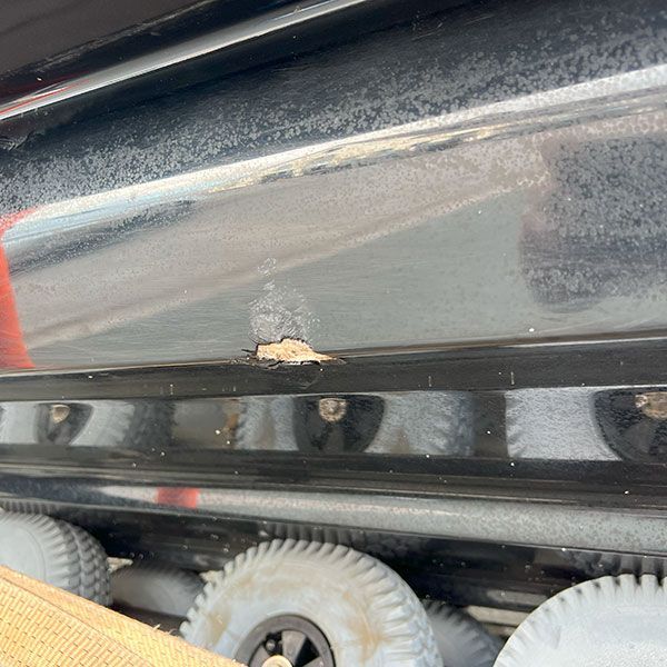 a close up of a car with a hole in the side .