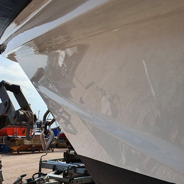 a white boat with the letters ts on the side