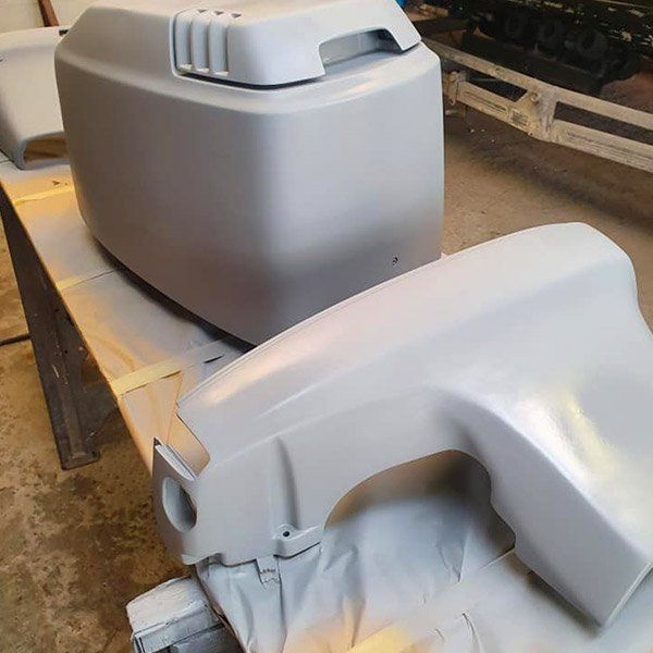 two pieces of plastic are sitting on top of a wooden table .