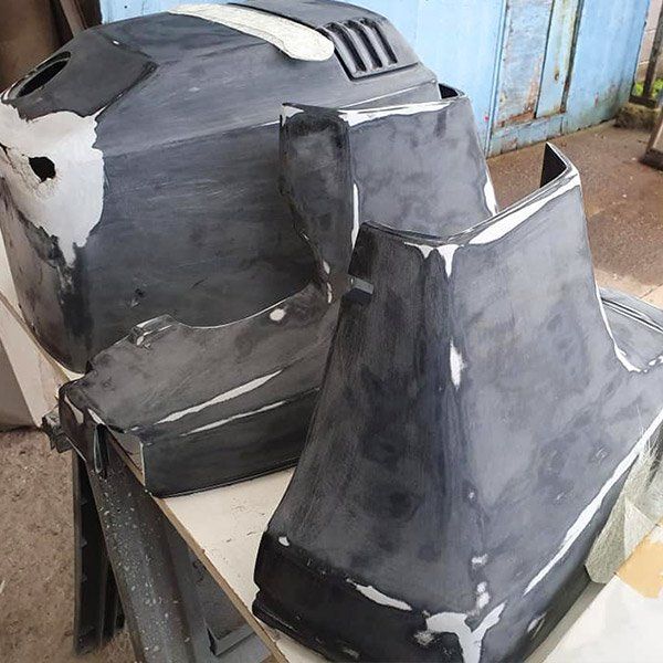 two pieces of black plastic are sitting on a table .