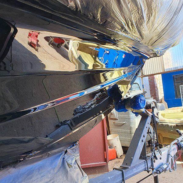 a boat is sitting on a trailer in front of a building