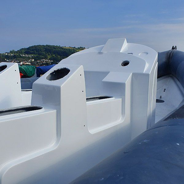 a white boat with a blue sky in the background