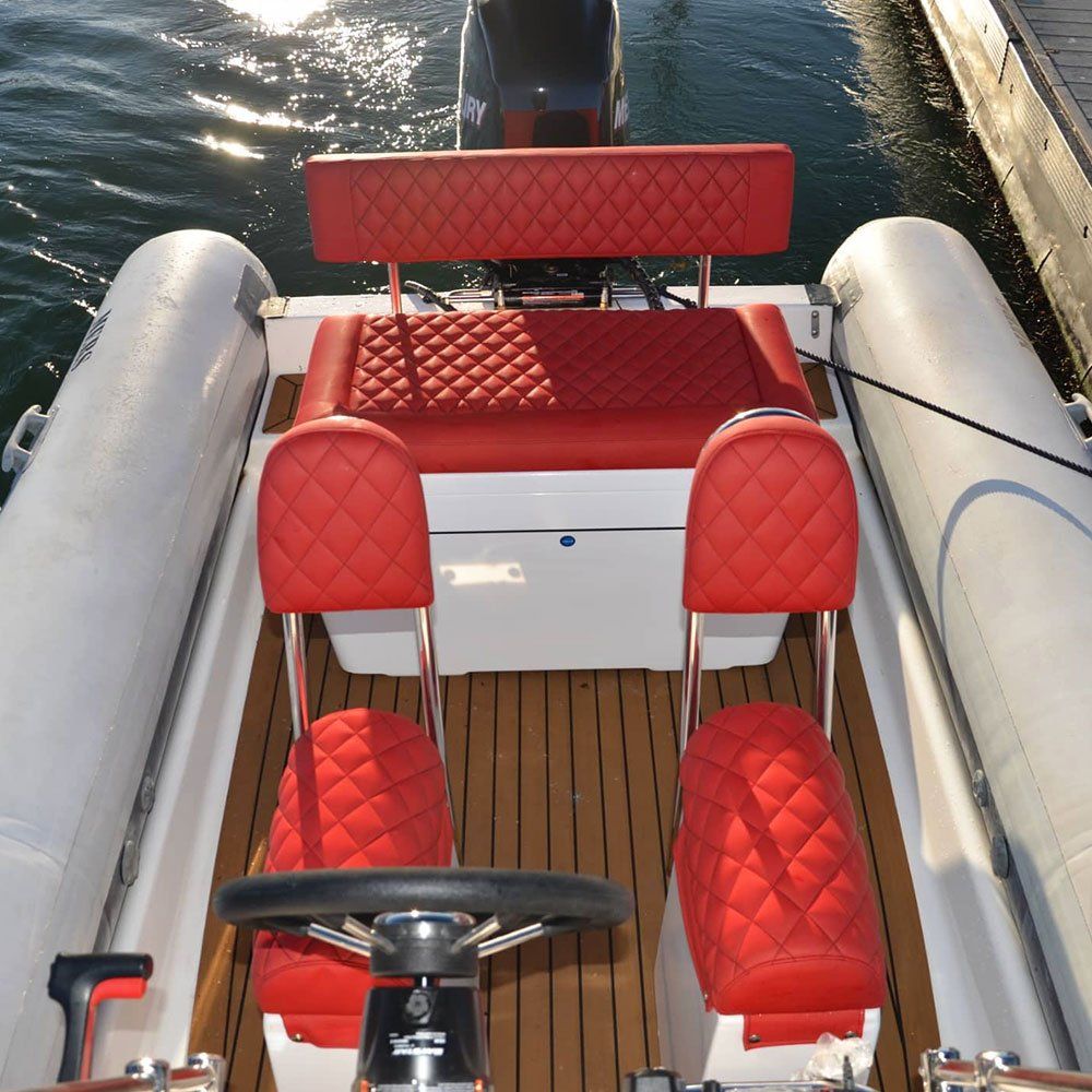 a boat with red seats and a steering wheel