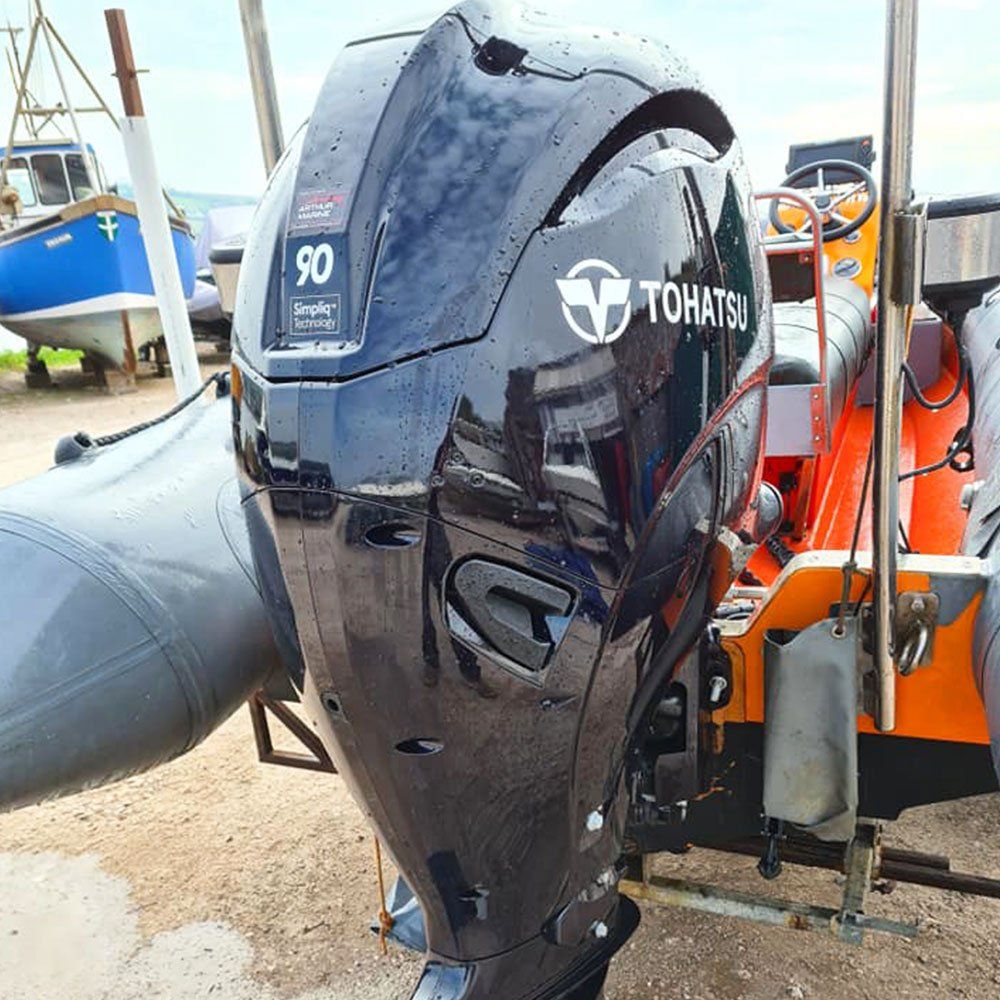 a tohatsu outboard motor is sitting on top of a boat .