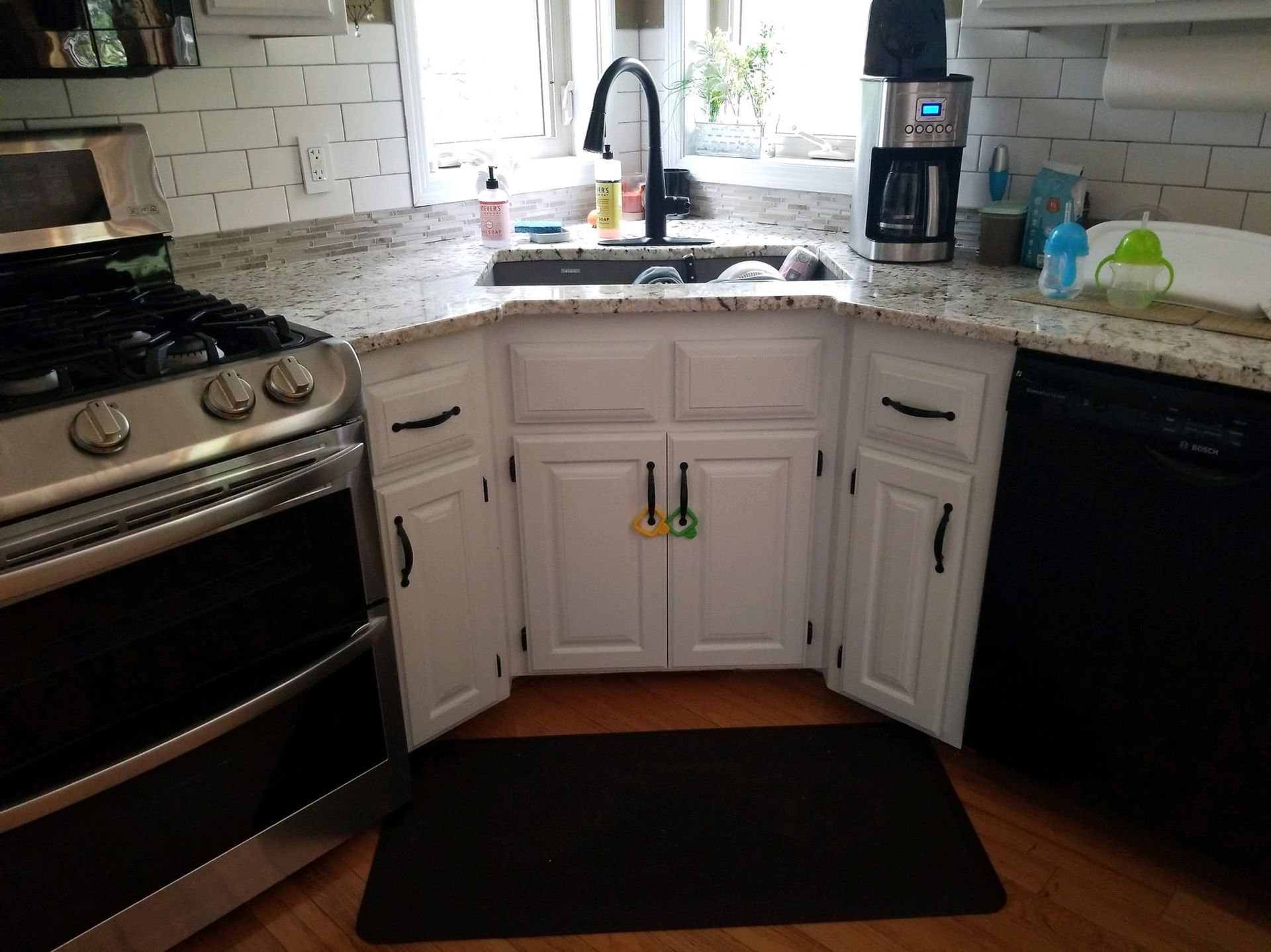 A kitchen with a stove , sink , and dishwasher.