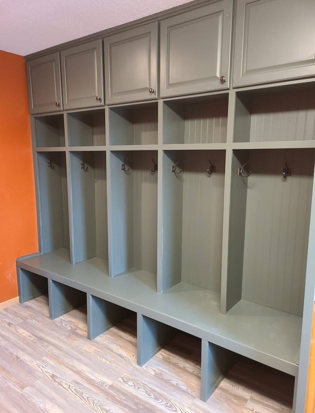 A locker room with lots of shelves and hooks on the wall.