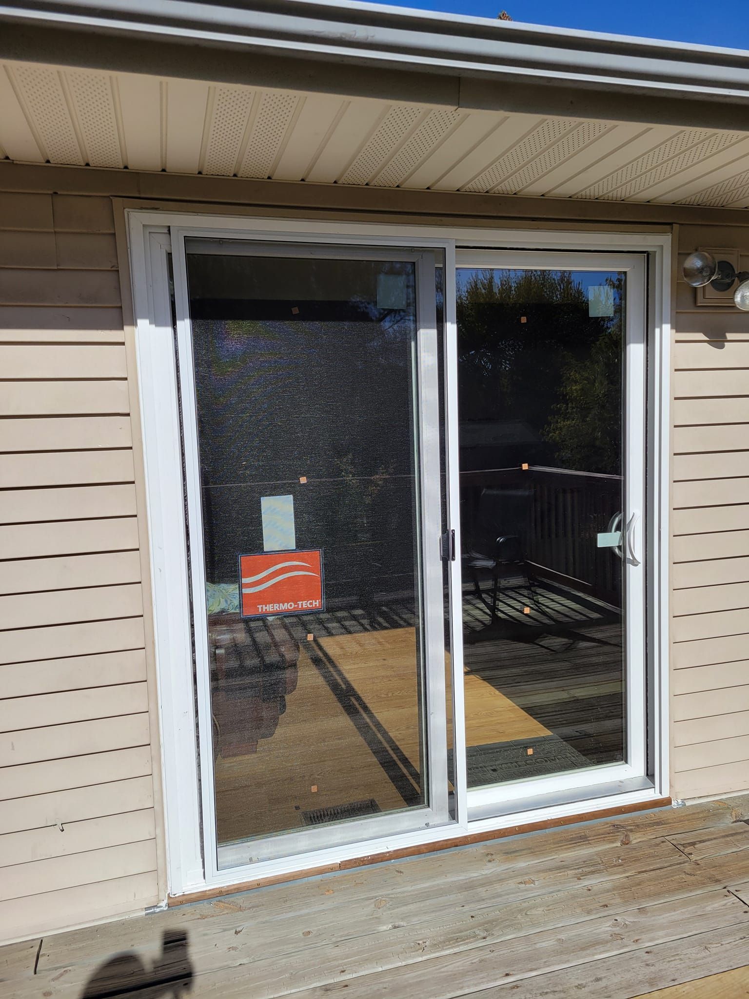 There is a sliding glass door on the side of a house.