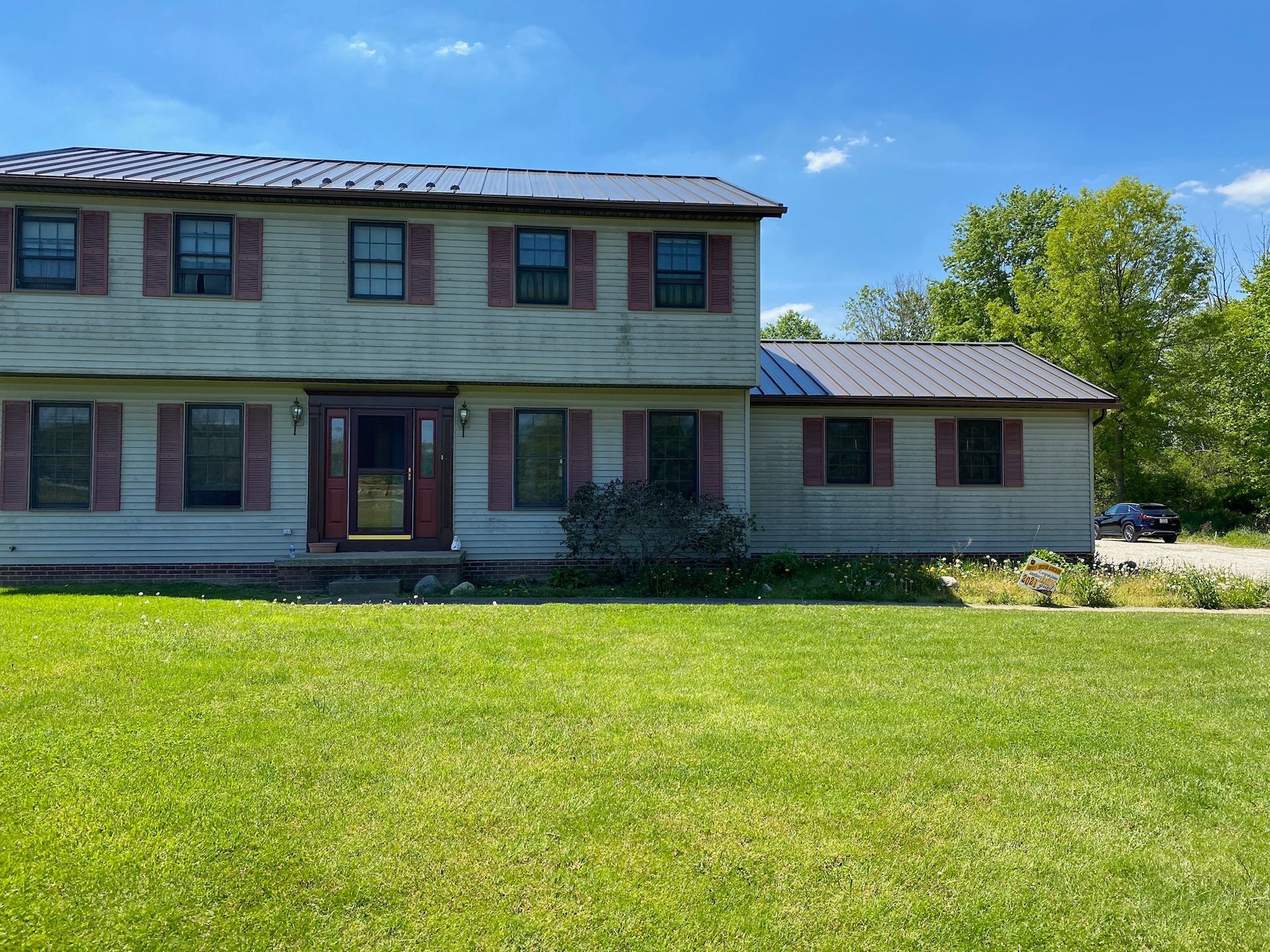 A large house with a lush green lawn in front of it.