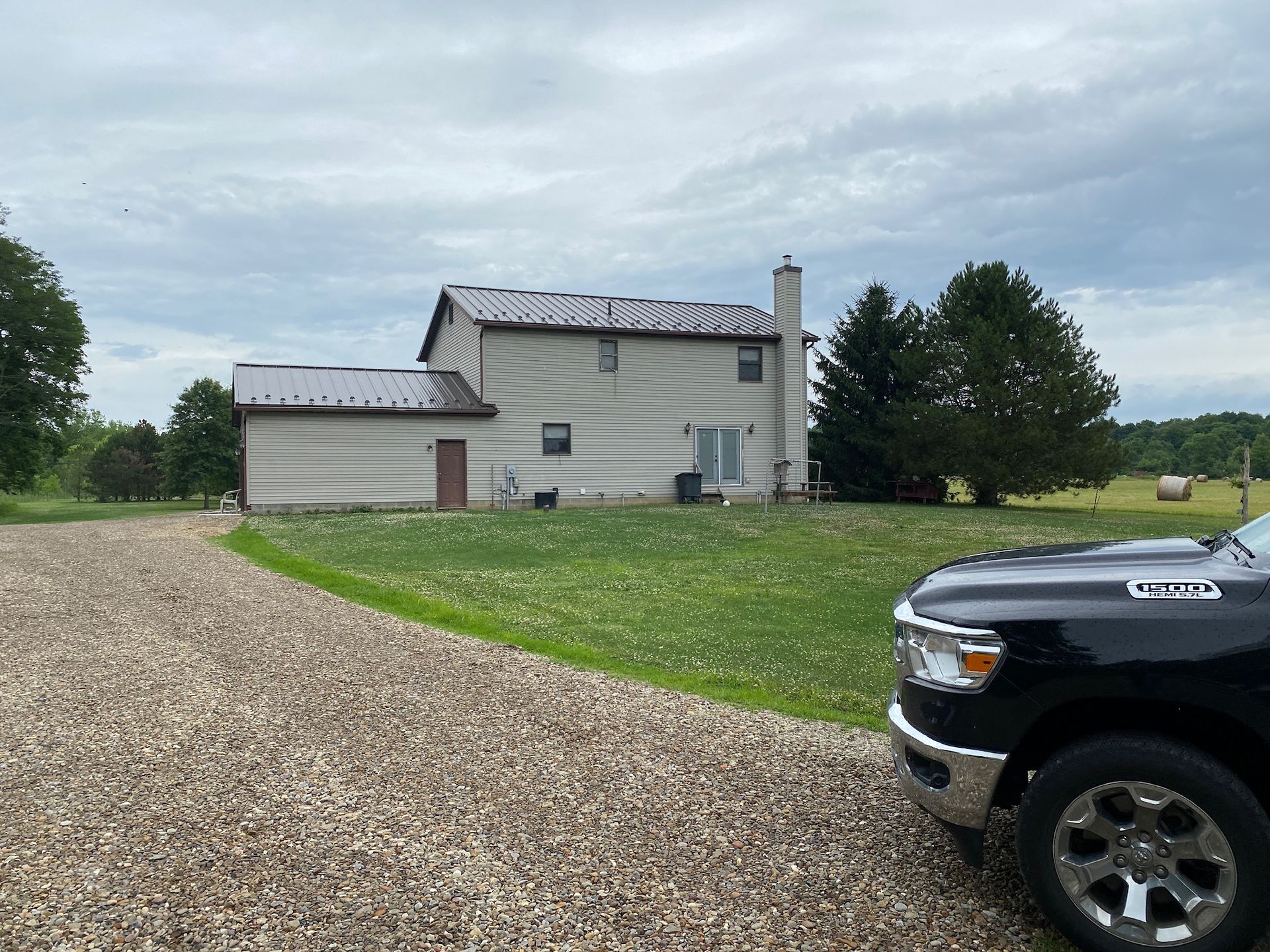 A black truck is parked in front of a house