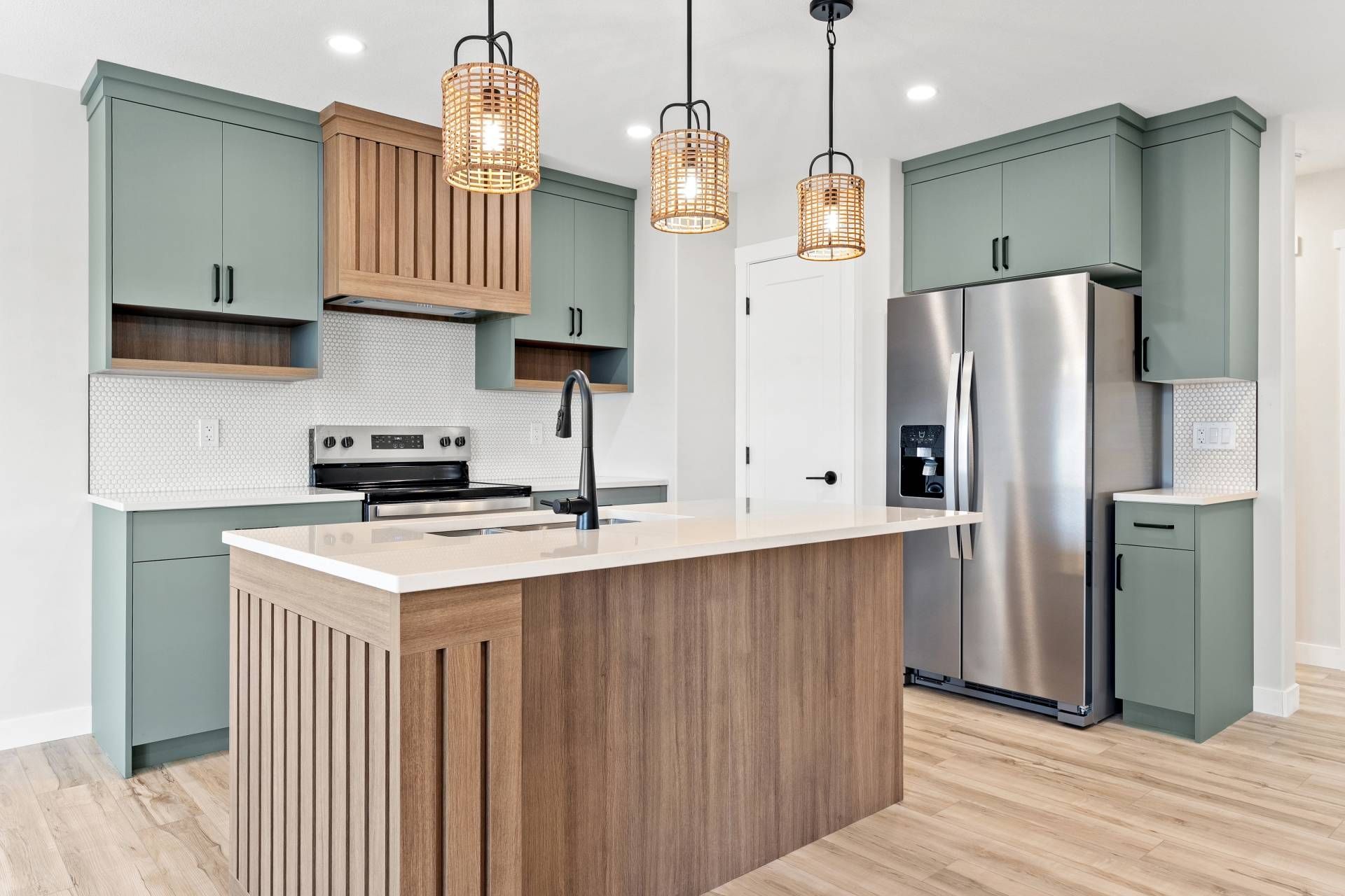 Modern bathroom with glass shower, skylight, and gray and white tiles. Black fixtures, white towels.