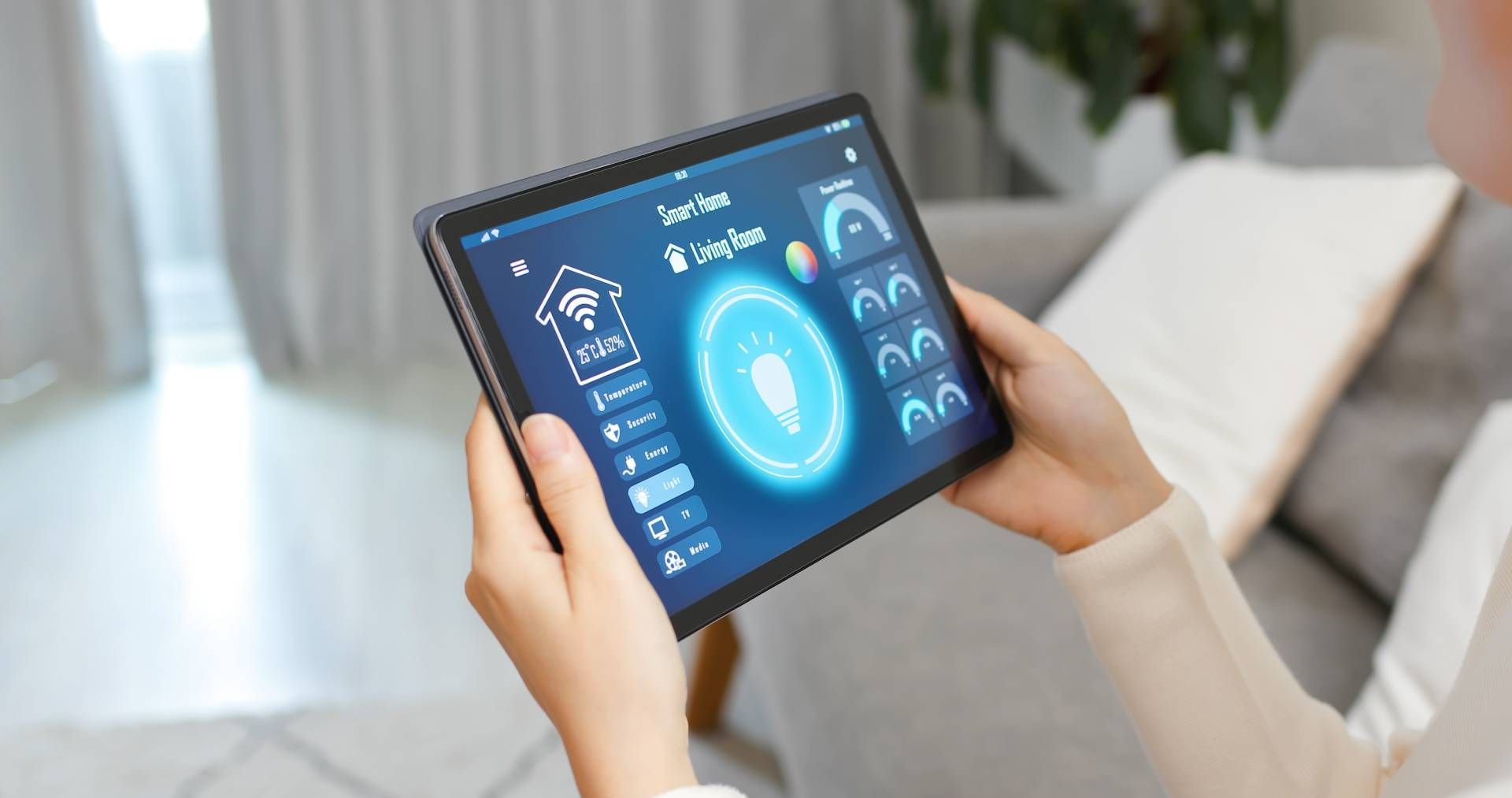 Woman holding a tablet controlling smart home devices with a blue and white interface.