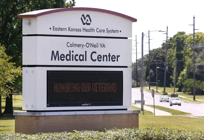 Sign for Colmery-O'Neil VA Medical Center, with message for veterans, in front of a road.
