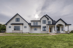 Shot of nice white house on a cloudy day — Cheyenne, WY — Frontier Siding Supply