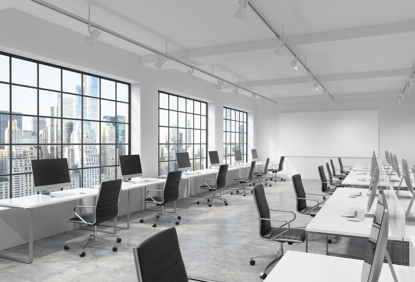 An empty office with a lot of windows and tables and chairs.