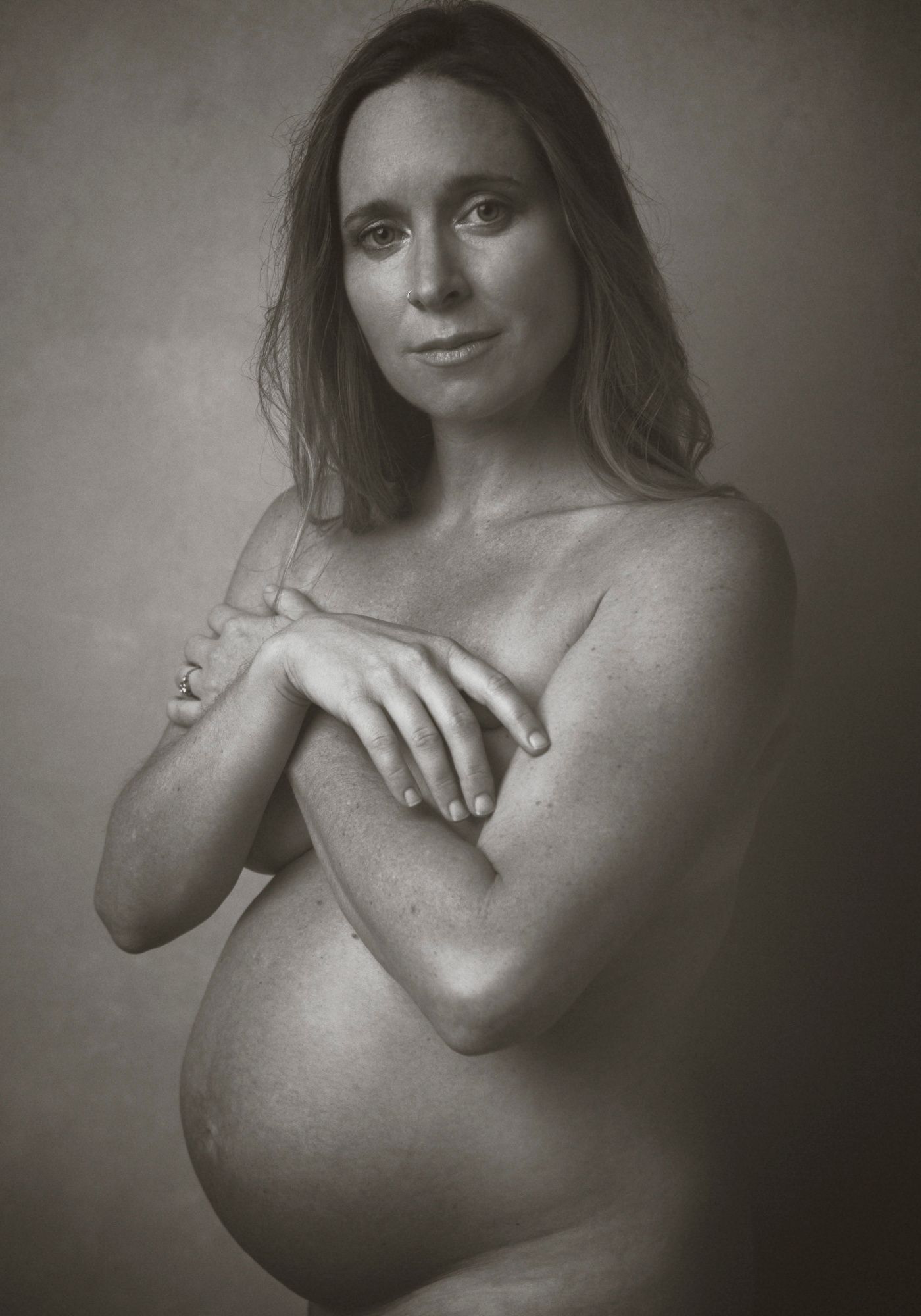 mother posed in maternity setting in Asheville photo studio