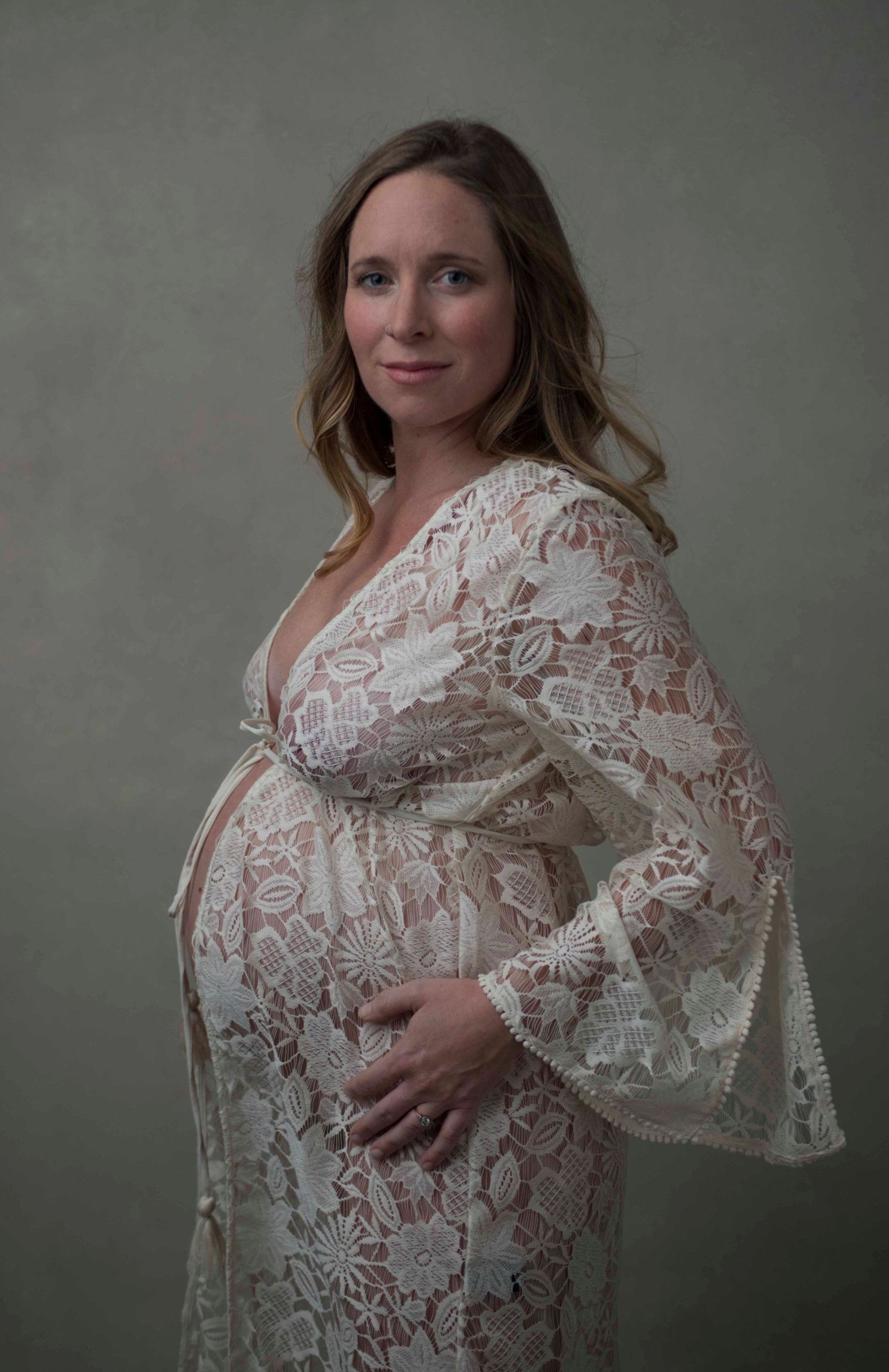 beautiful mother in maternity dress, posed in asheville photo studio