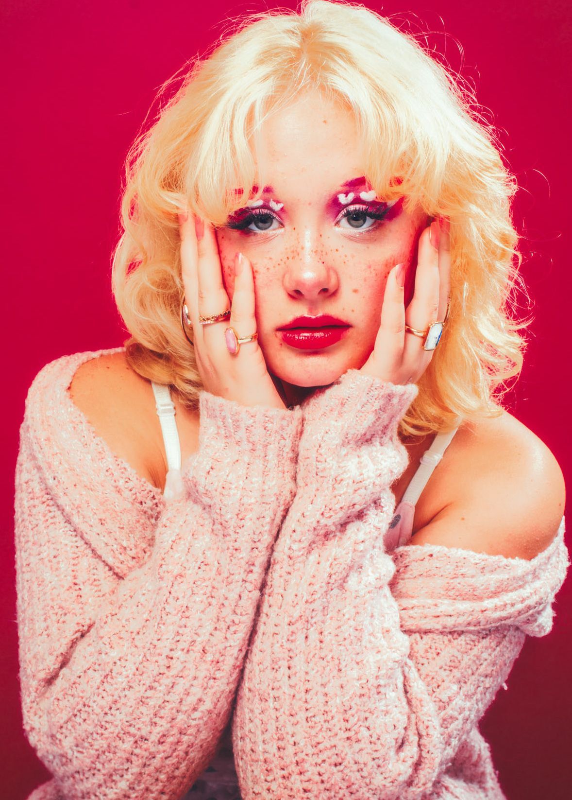 asheville maternity model posing in studio for maternity session with red scarf
