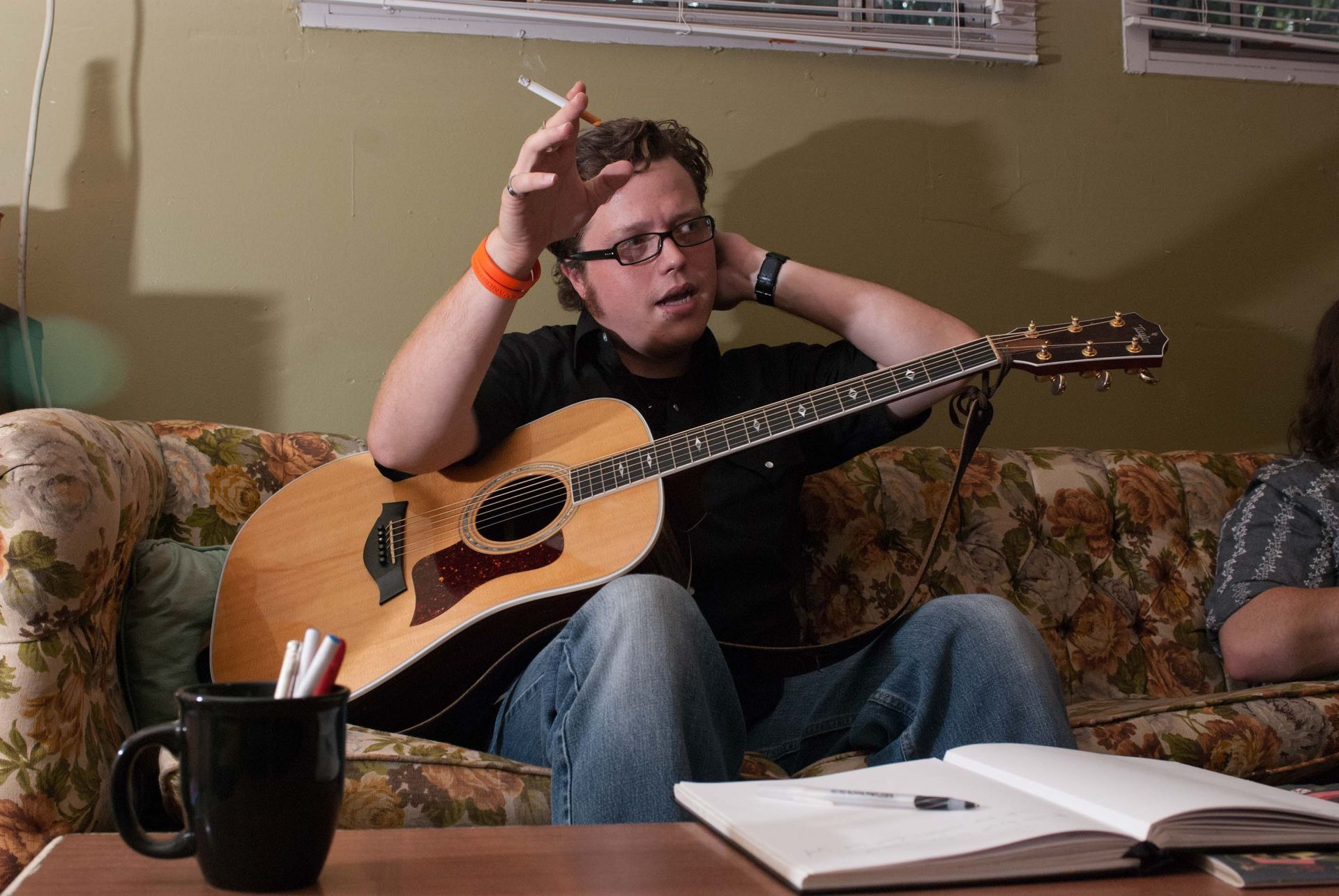 singer Jason Isbell rests backstage at Grey Eagle