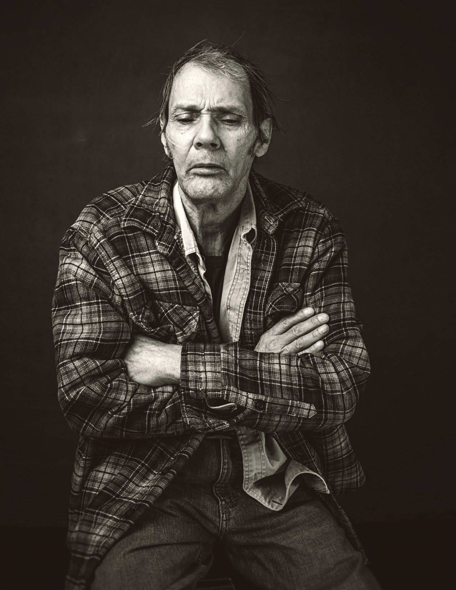 Malcolm Holcombe crossed arms photo in flannel shirt 