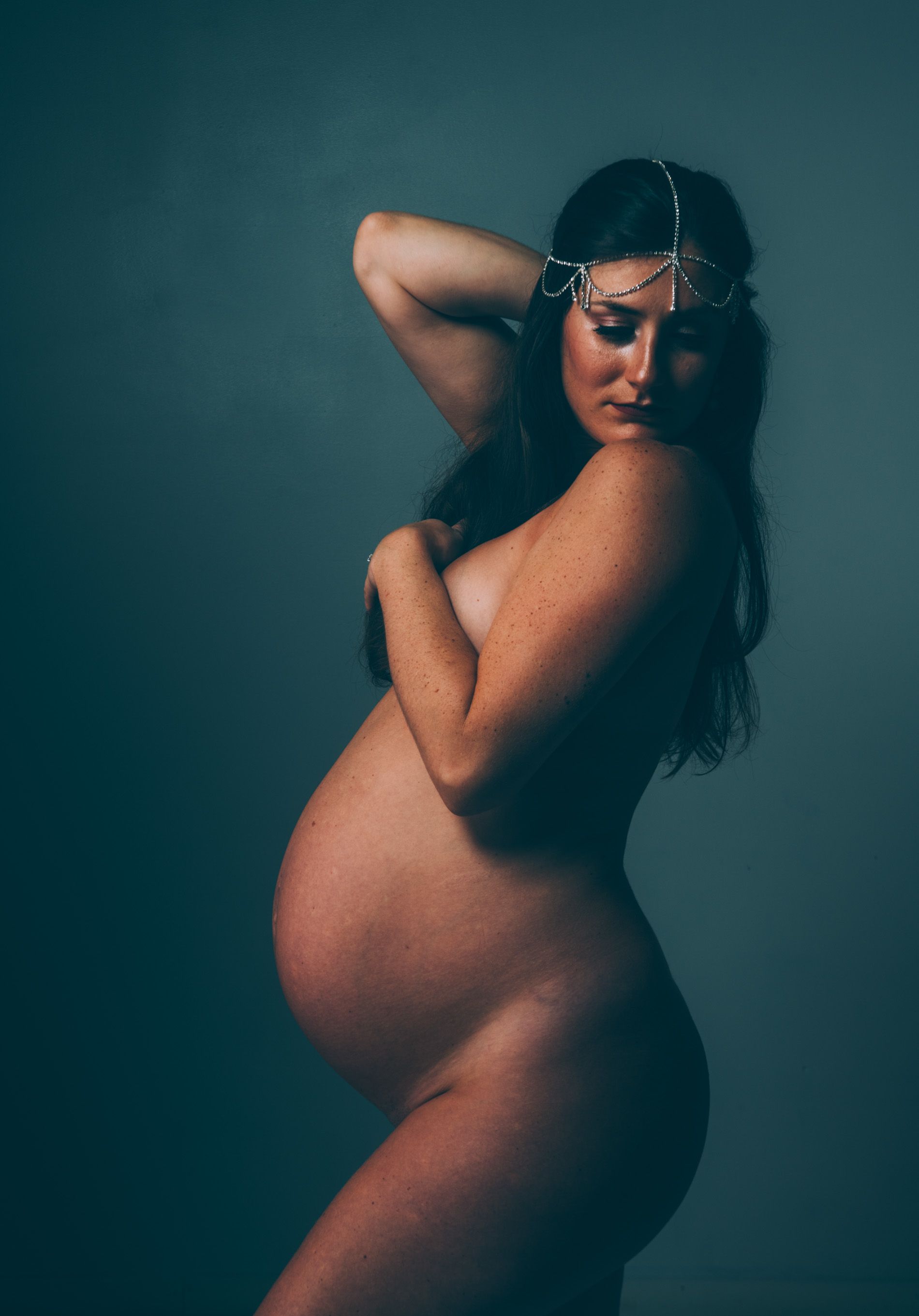  maternity photo portrait of a pregnant Asheville, North Carolina mother in western nc photographer studio, classic implied pose at 33 weeks pregnant in maternity dress