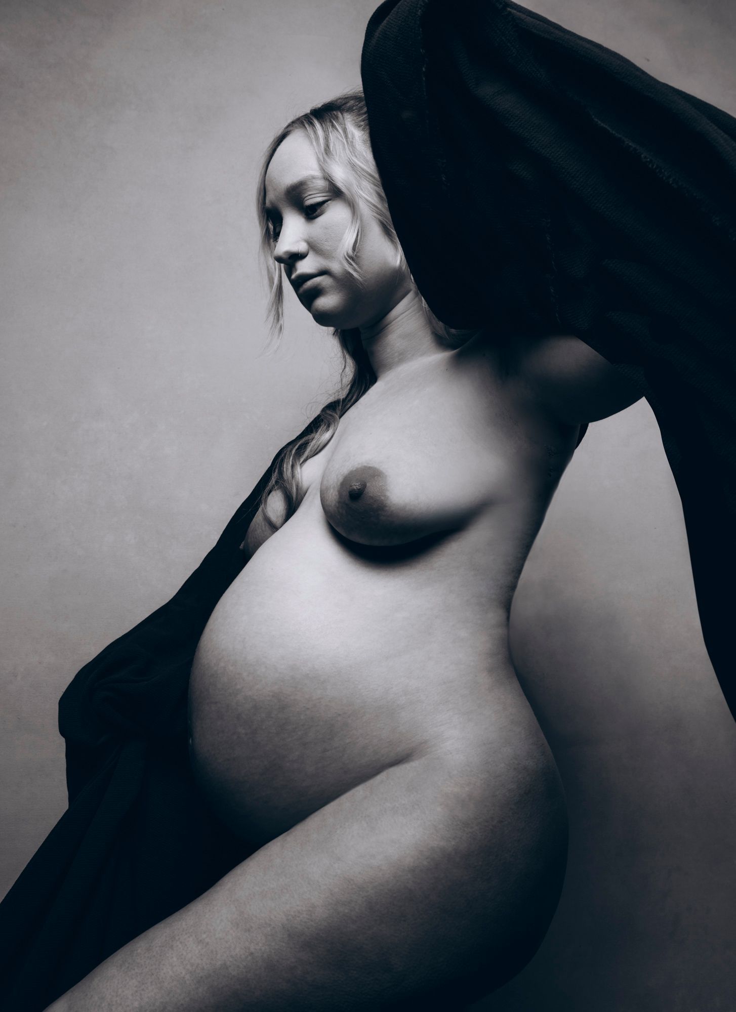 classic nude posed asheville mother and maternity model posed in a classic black and white image in photo studio for pregnancy photography session