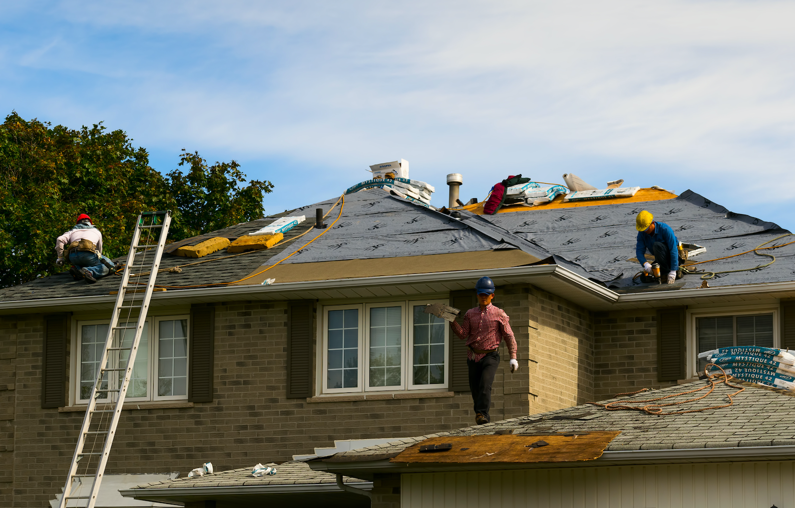 Men re-shingling a house