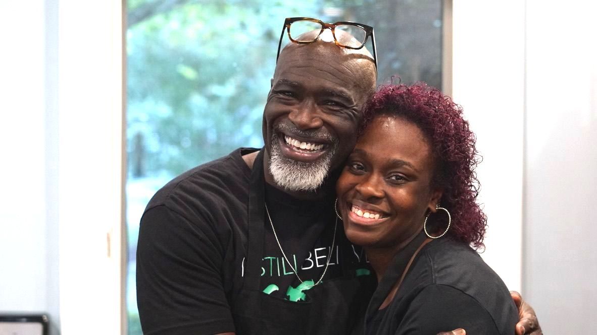 a man and a woman are posing for a picture together and smiling .