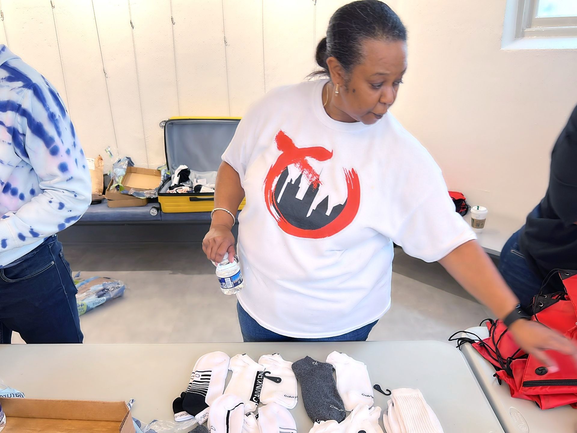 a woman wearing a white shirt with a red circle on it