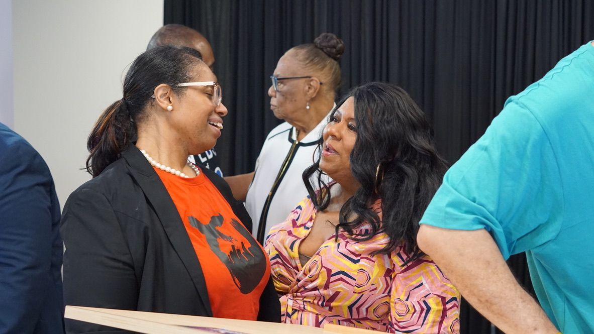 a group of women are standing next to each other in a room .