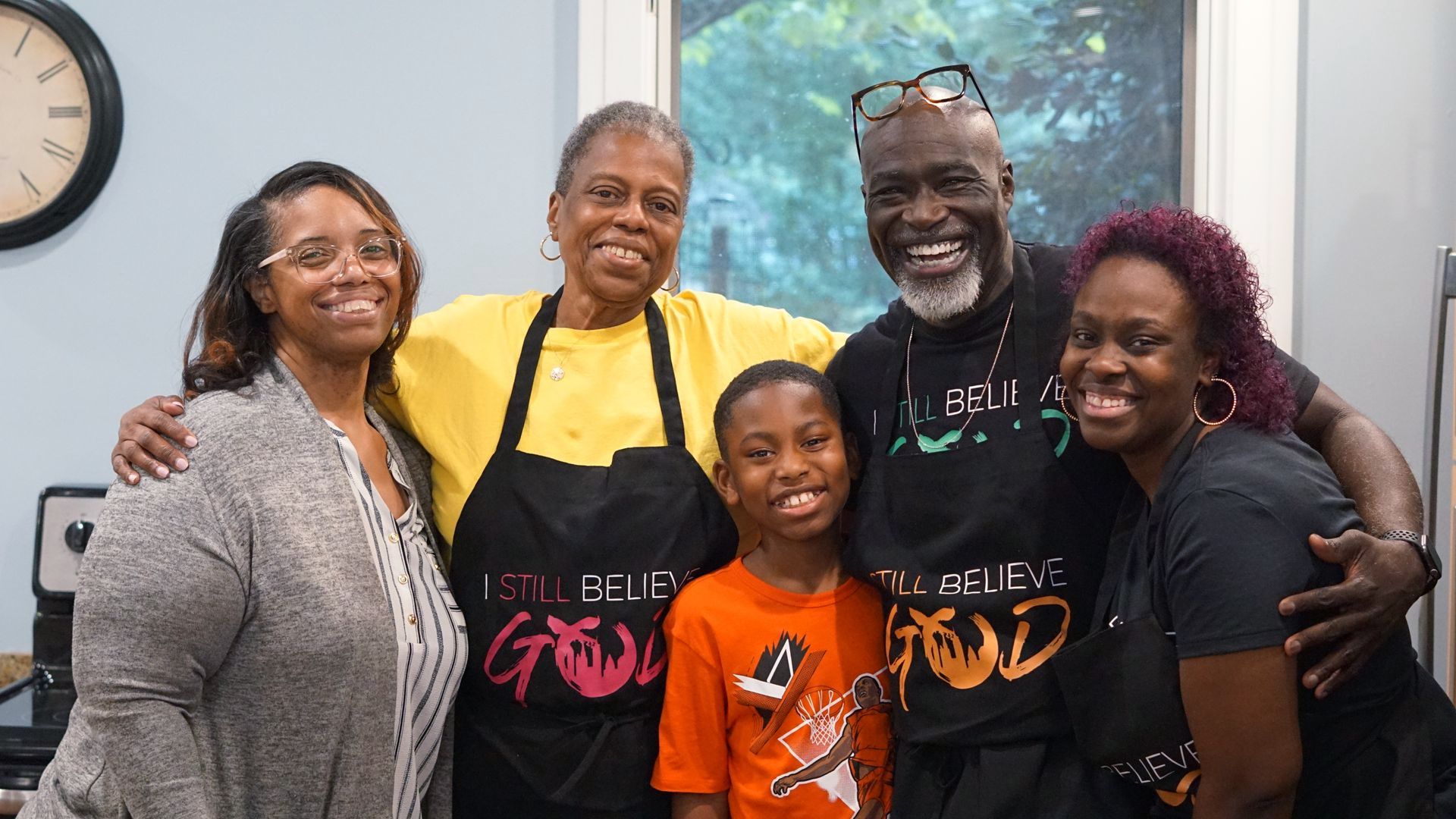a group of people are posing for a picture together some with aprons on.