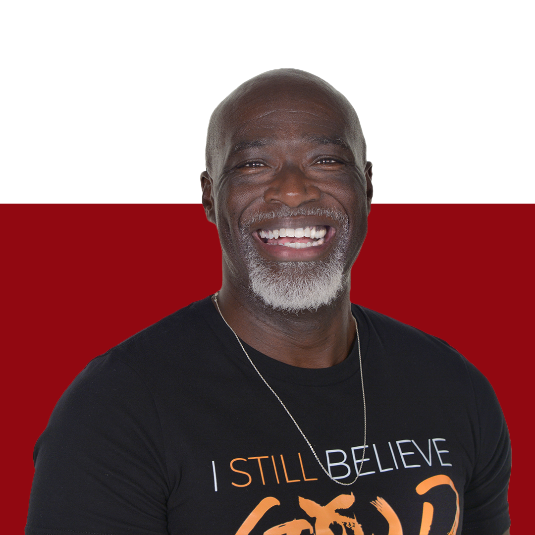 a man wearing a black shirt that says i still believe