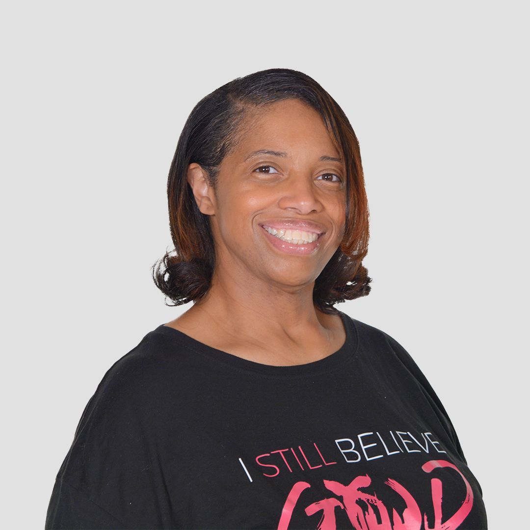 a woman wearing a black shirt that says i still believe god