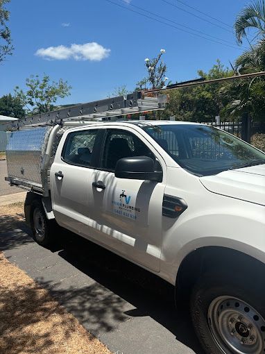 A Bunch of Plumbing Tools Are Lined Up on a White Surface — Vision Plumbing Queensland in Pimlico, QLD