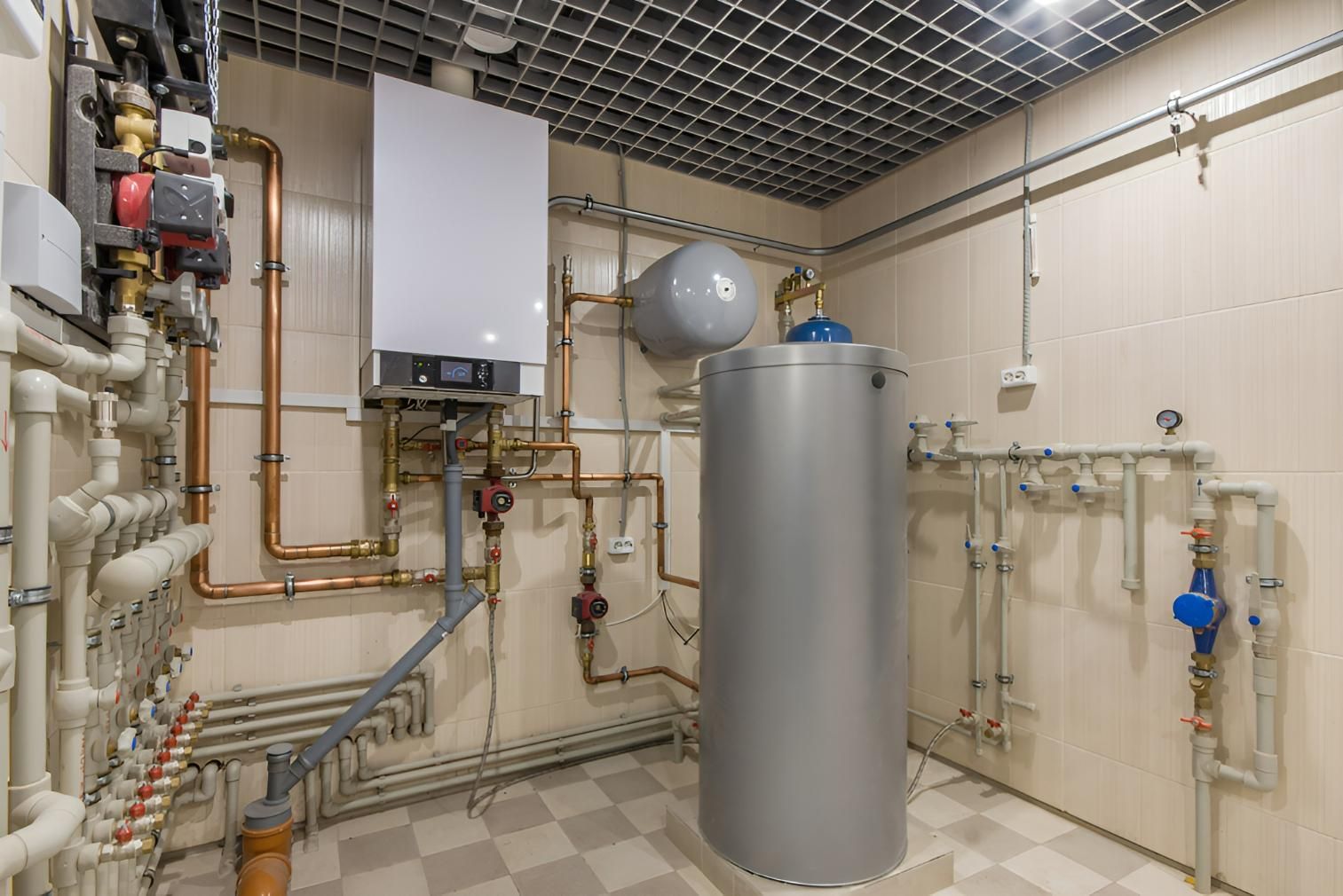 A Room With a Water Heater and Pipes in It — Vision Plumbing Queensland in Pimlico, QLD