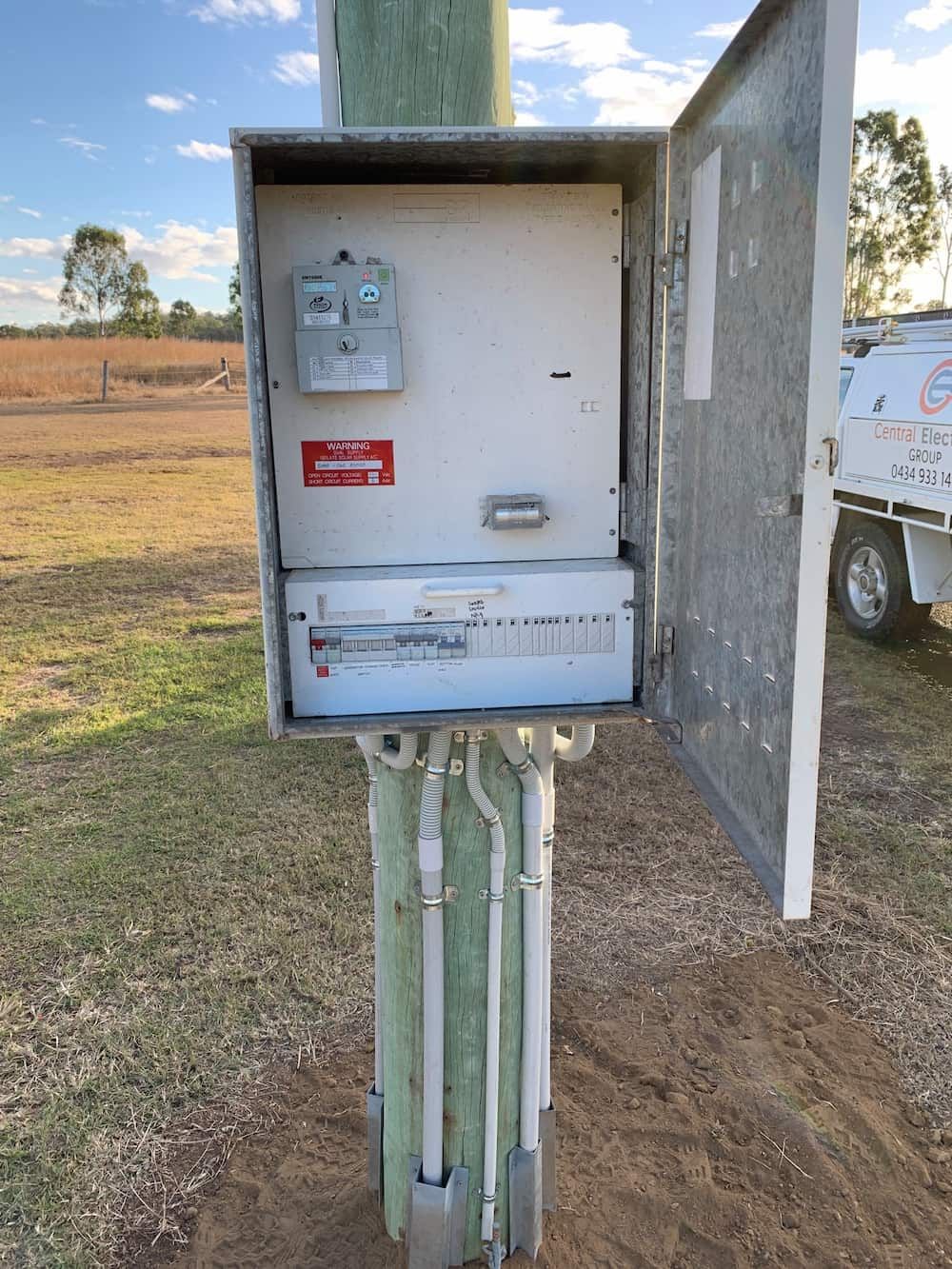 A White Box is Sitting on Top of a Wooden Pole — Central Electrical Group in Gladstone Central, QLD
