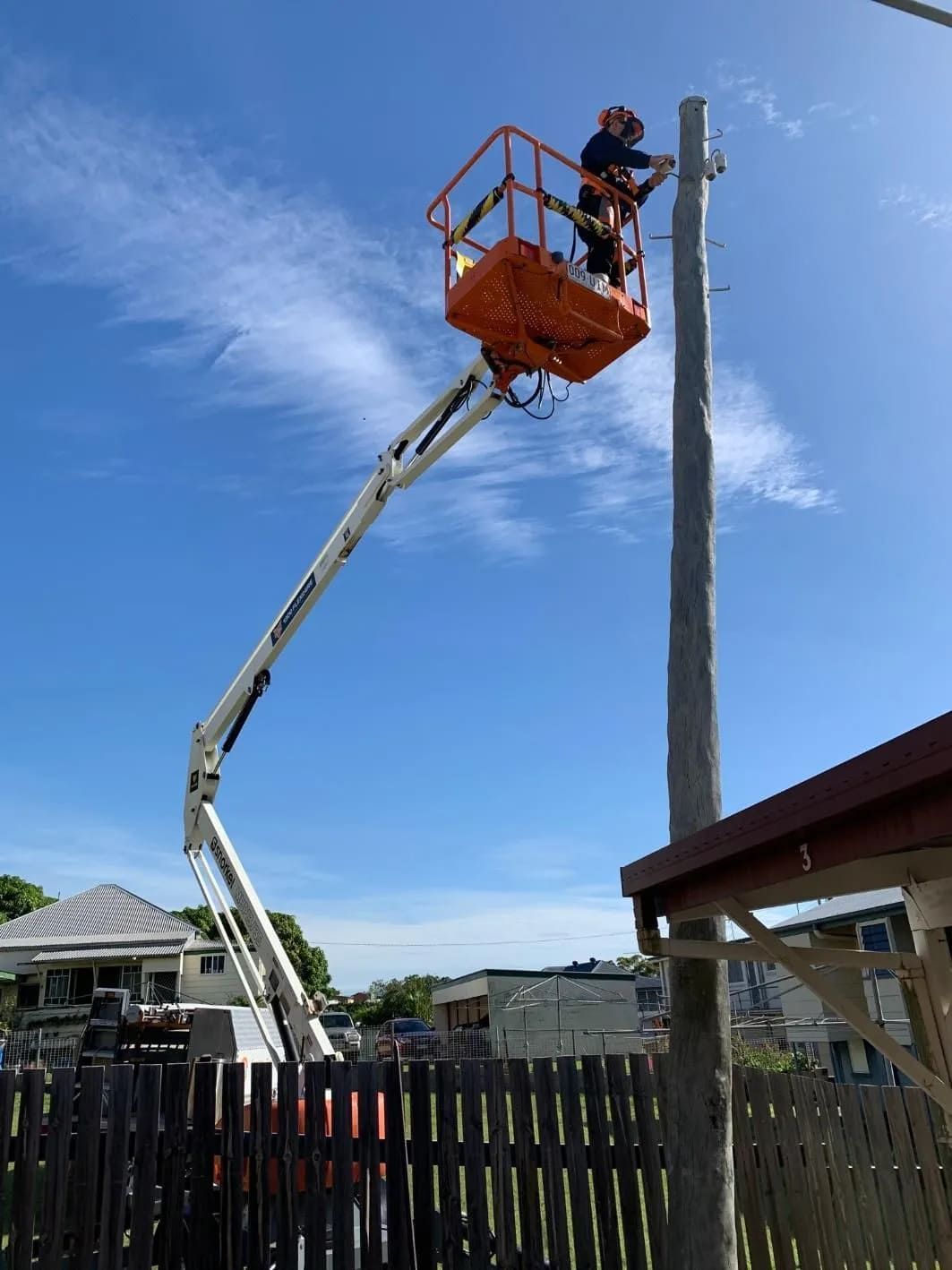 A Man is Working on a Pole on a Crane — Central Electrical Group in Gladstone Central, QLD