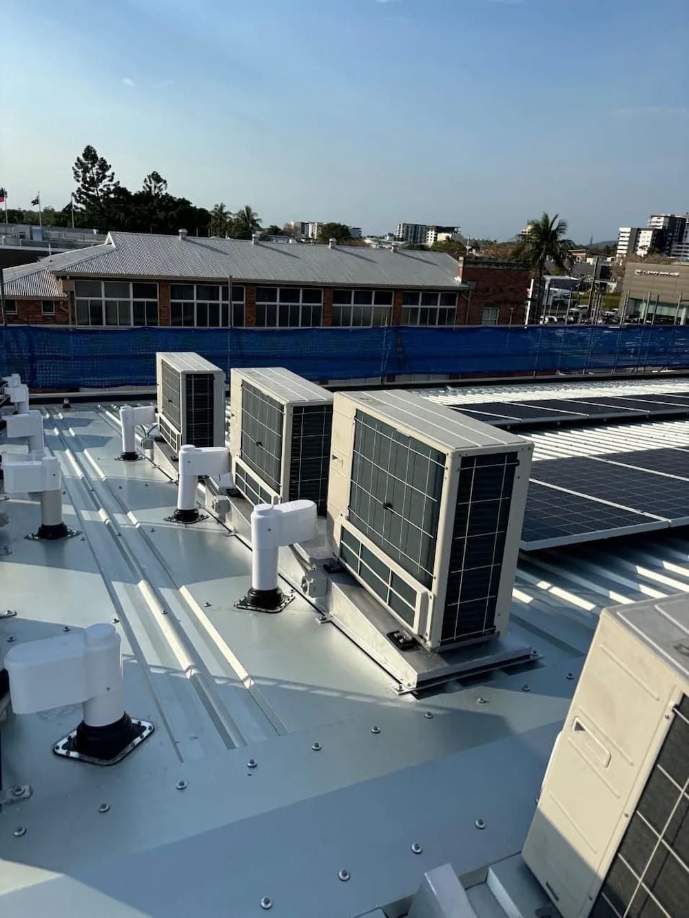 There Are a Lot of Air Conditioners on the Roof of a Building — Central Electrical Group in Gladstone Central, QLD