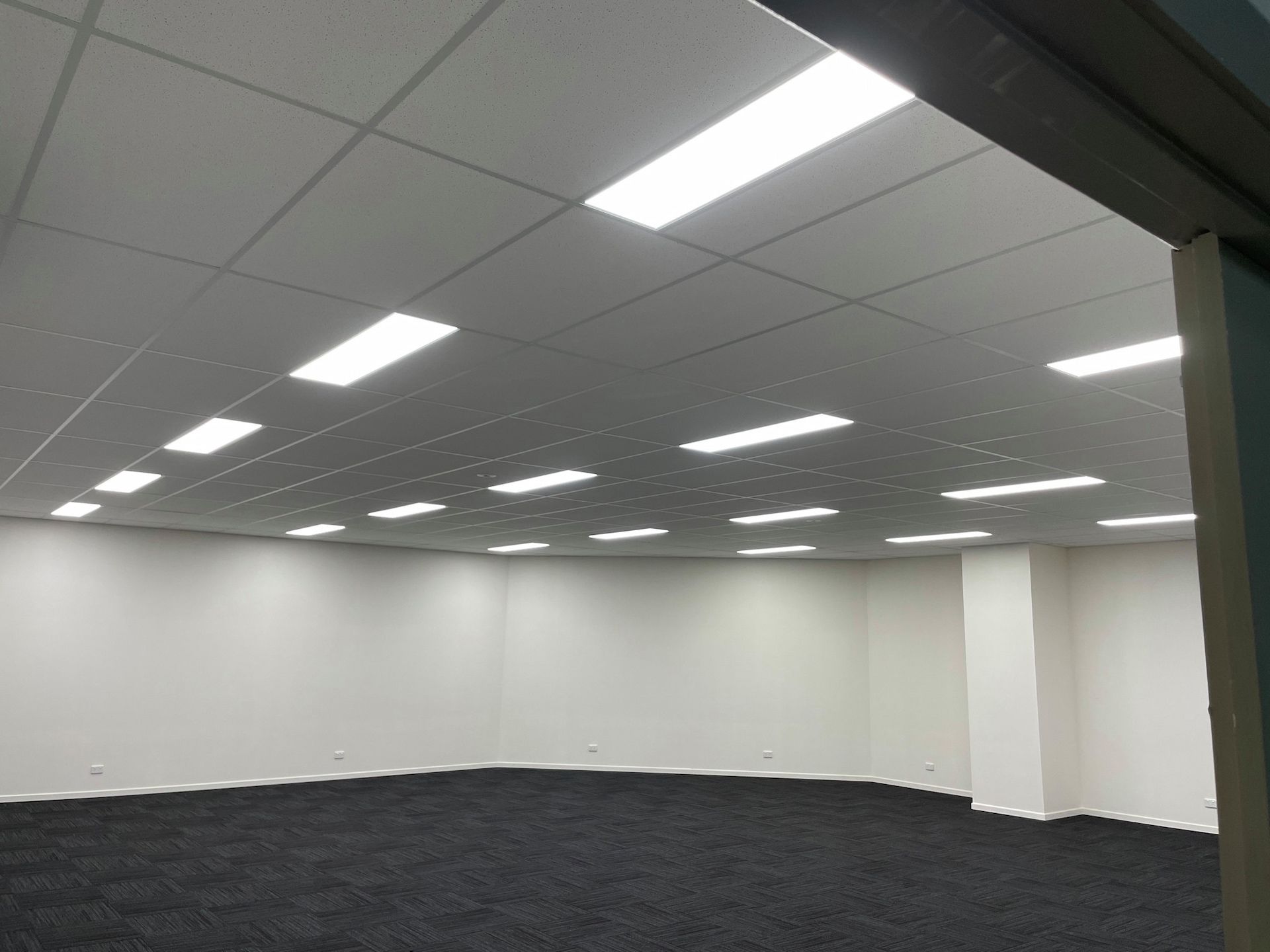 A Large Empty Room With a Ceiling That Has a Lot of Lights on It — Central Electrical Group in Gladstone Central, QLD